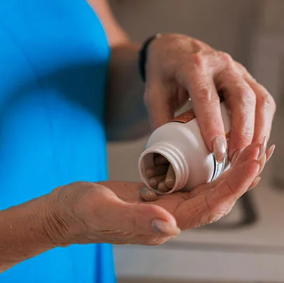 A supplement bottle with capsules poured out beside it