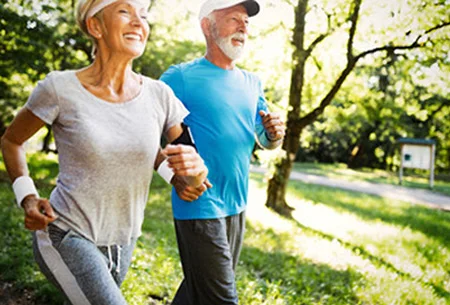 Active older couple walking outdoors together