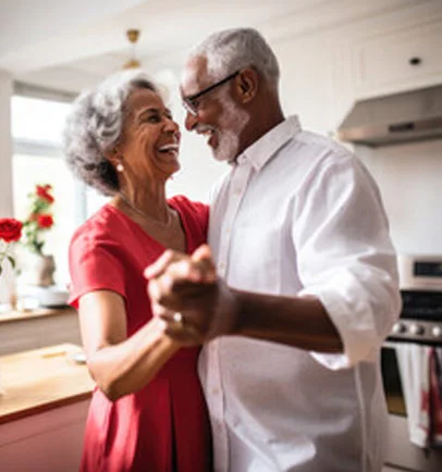 Older couple dancing together at home