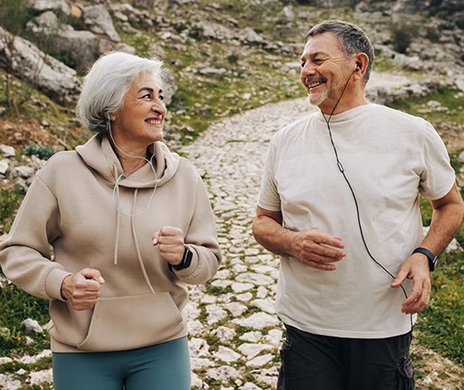 Couple jogging together on a bright morning