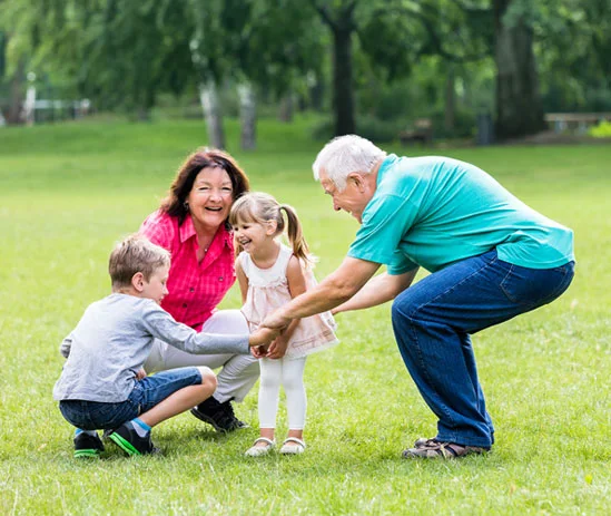 Grandparents playing outdoors with their family