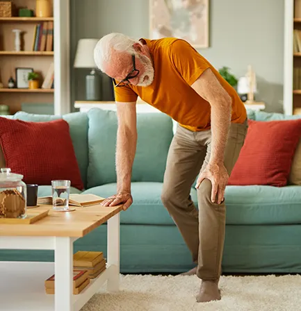 A person easing joint discomfort in the hand, for a guide to relieving joint pain naturally